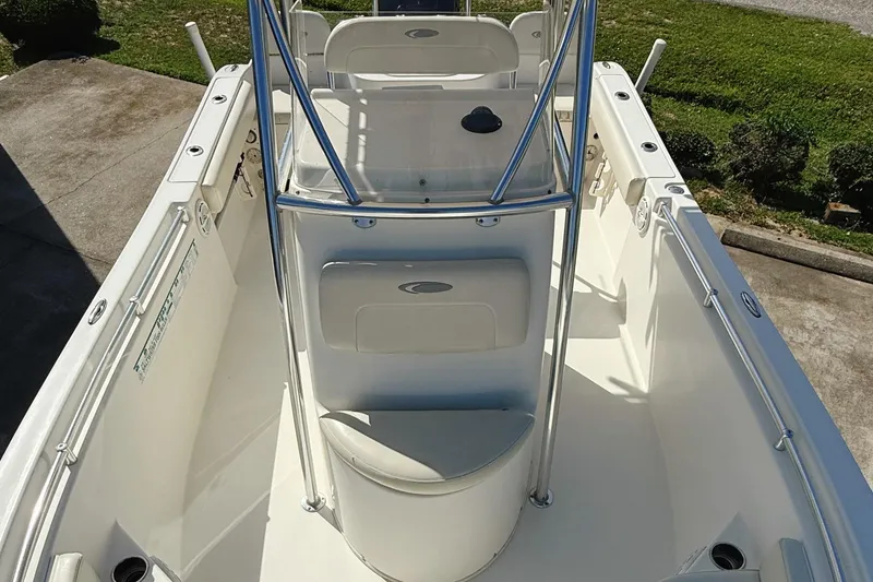 Slide: The Image of 2012 Cobia 217 Center Console boat interior with seating and console view. - 6