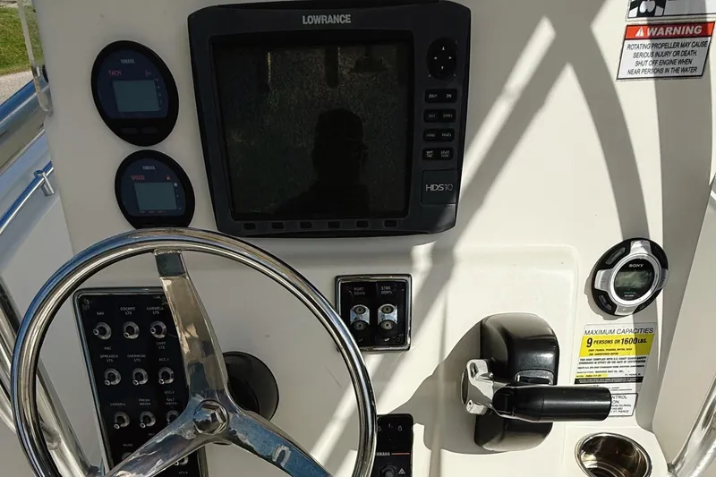 Slide: The Image of 2012 Cobia 217 Center Console dashboard with steering wheel, gauges, and controls. - 7