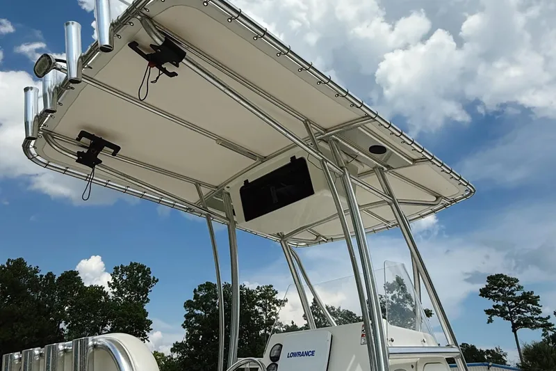 Slide: The Image of 2012 Cobia 217 Center Console boat with T-top under a blue sky. - 9