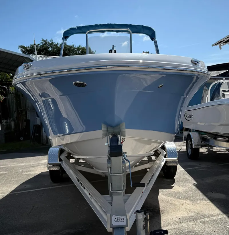 Slide: The Image of 2025 Robalo R200 Center Console boat on trailer, front view, sunny day. - 2