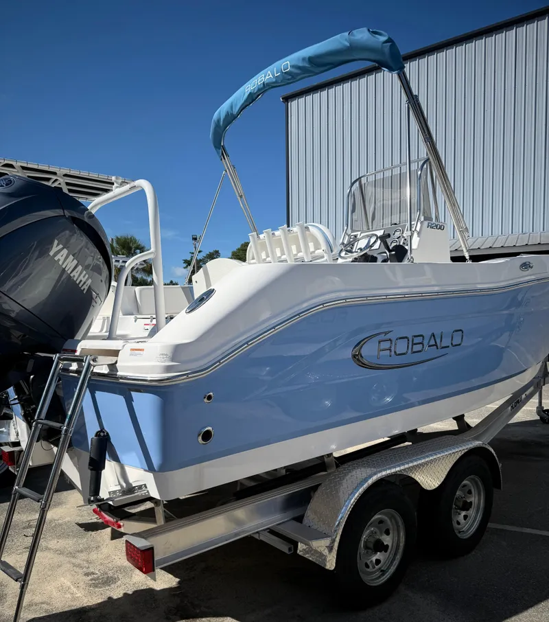 Slide: The Image of 2025 Robalo R200 Center Console boat on trailer, featuring Yamaha engine. - 3