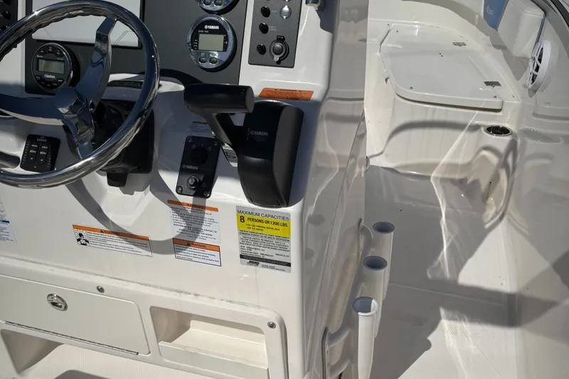 Slide: The Image of 2025 Robalo R200 Center Console boat interior with steering wheel and control panel. - 8