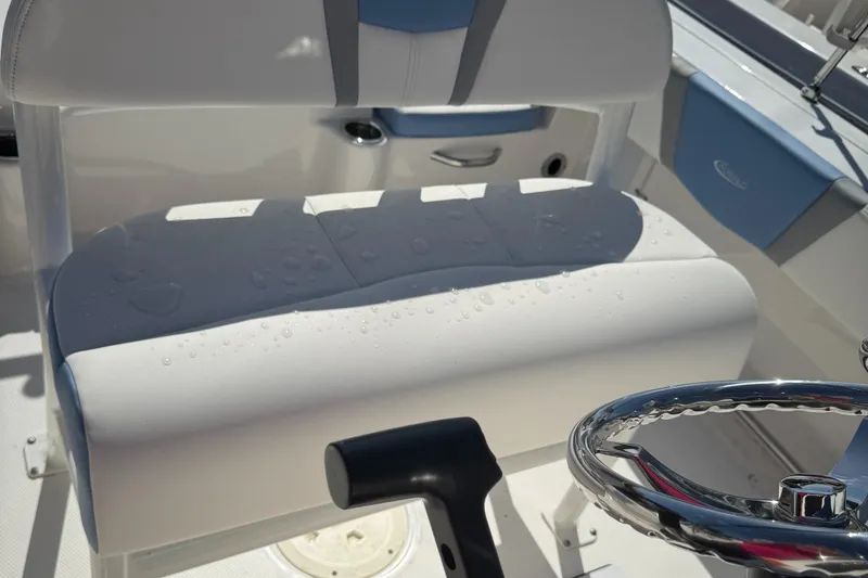 Slide: The Image of 2025 Robalo R200 Center Console boat interior with wet seat and steering wheel. - 9