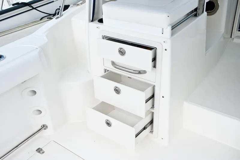 Slide: The Image of Manufacturer Provided Image: 2019 Boston Whaler 285 Conquest storage drawers in white interior. - 15