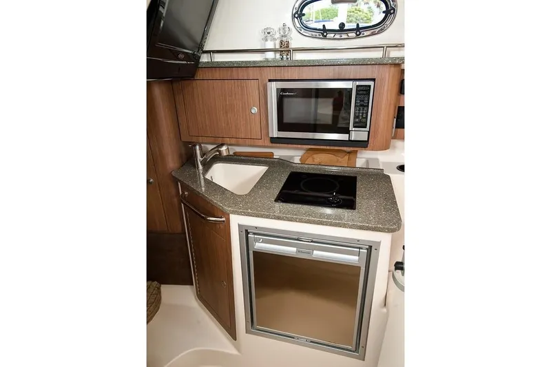 Slide: The Image of Manufacturer Provided Image: 2019 Boston Whaler 285 Conquest galley with microwave, sink, stove, and refrigerator. - 21
