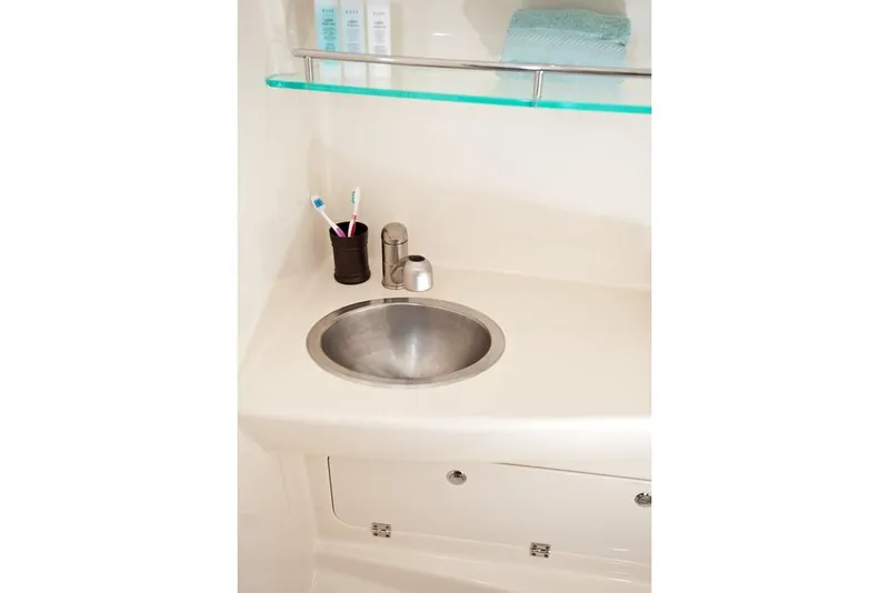 Slide: The Image of Manufacturer Provided Image: 2019 Boston Whaler 285 Conquest bathroom sink with toiletries and storage. - 22