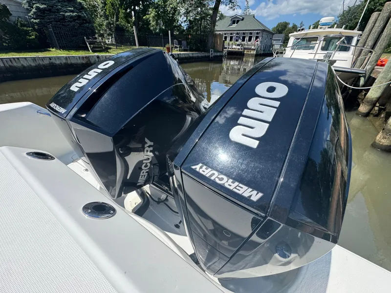 Slide: The Image of Twin Mercury outboard engines on a 2019 Boston Whaler 285 Conquest boat. - 28