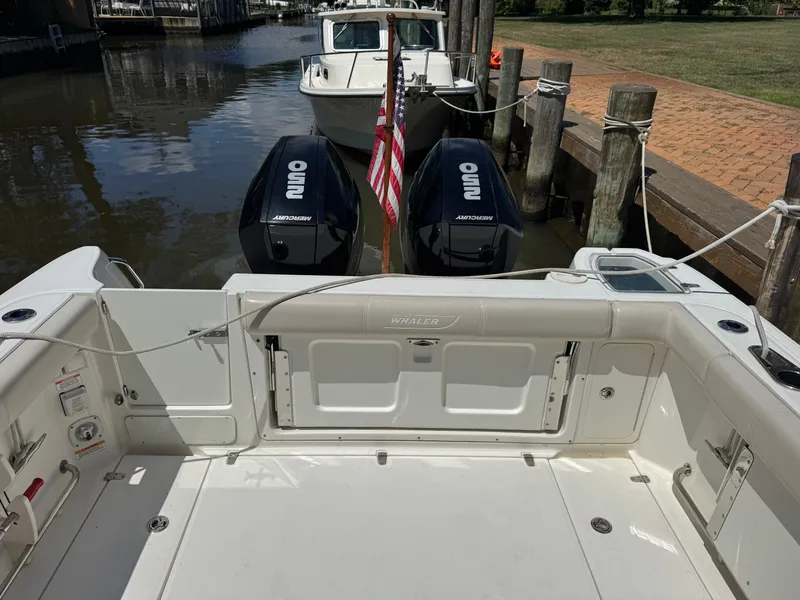 Slide: The Image of 2019 Boston Whaler 285 Conquest docked, featuring dual Mercury outboard engines. - 29