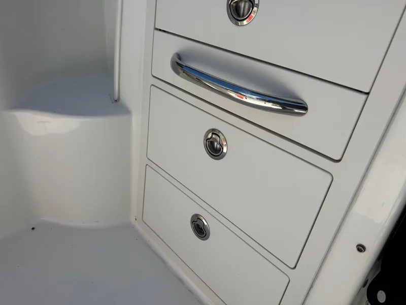 Slide: The Image of 2019 Boston Whaler 285 Conquest boat storage drawers with chrome handles. - 31