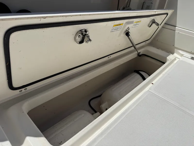 Slide: The Image of Open storage compartment on a 2019 Boston Whaler 285 Conquest boat. - 32