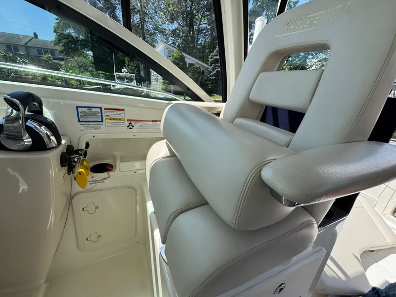 Slide: The Image of 2019 Boston Whaler 285 Conquest interior with plush seating and control panel. - 34