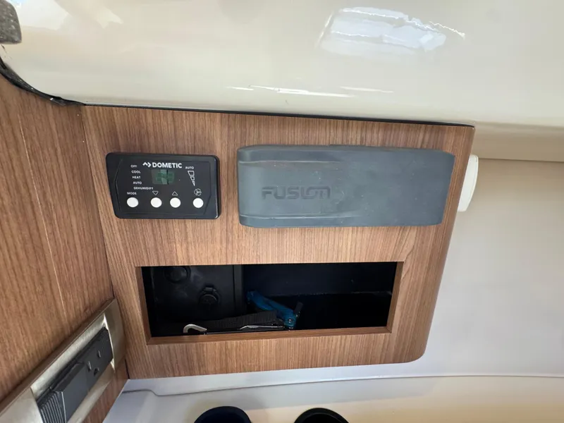 Slide: The Image of Control panel and storage on 2019 Boston Whaler 285 Conquest boat interior. - 43
