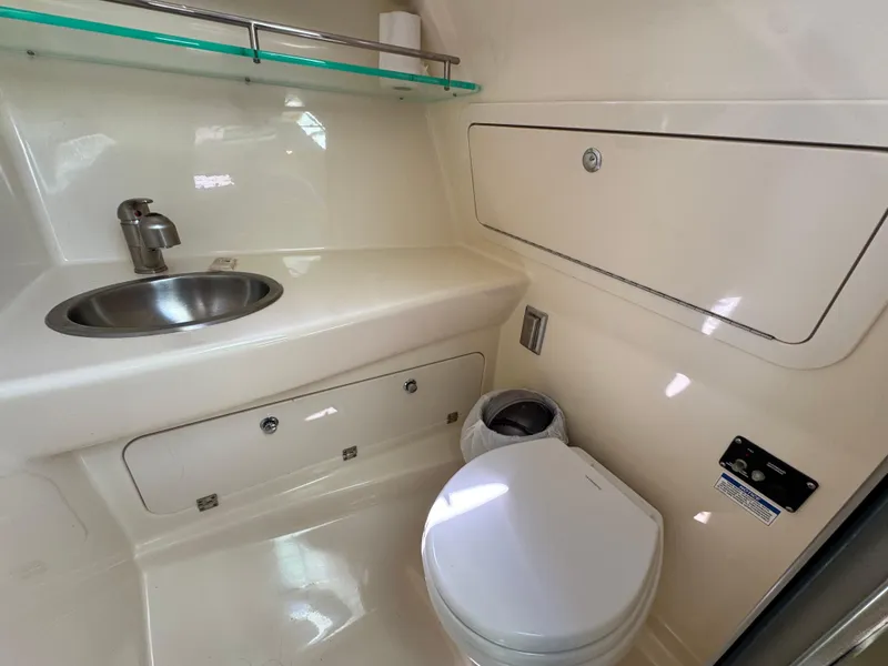 Slide: The Image of 2019 Boston Whaler 285 Conquest bathroom with sink, toilet, and storage. - 44