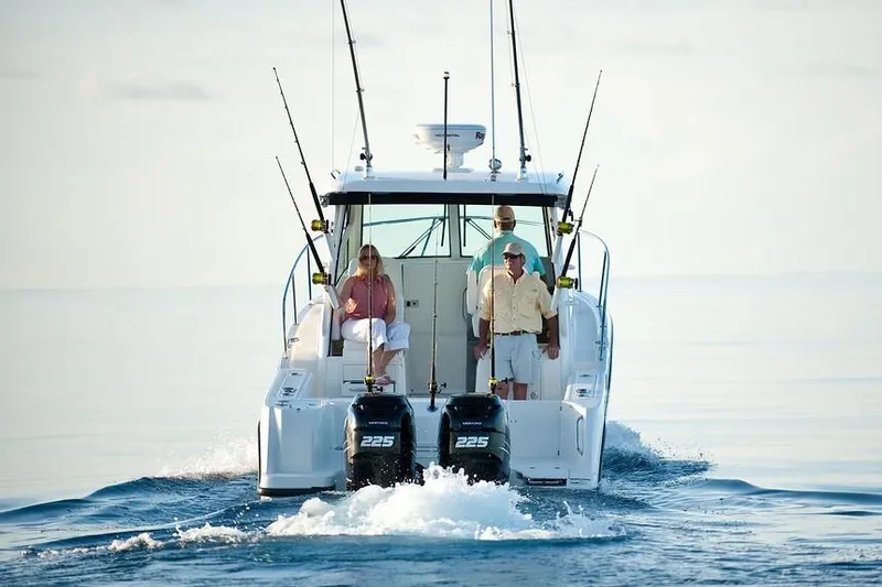 Slide: The Image of Manufacturer Provided Image: 2019 Boston Whaler 285 Conquest boat with passengers on calm water. - 6