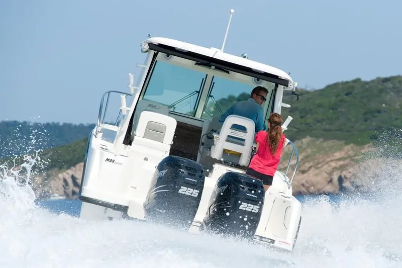 Slide: The Image of Manufacturer Provided Image: 2019 Boston Whaler 285 Conquest boat cruising on water with two people onboard. - 7