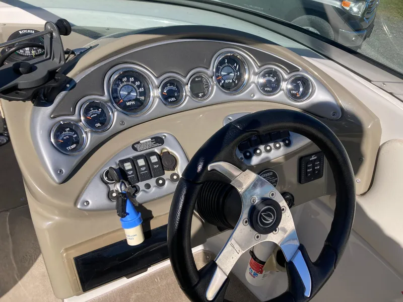 Slide: The Image of Dashboard of a 2007 Crownline 260 LS boat with steering wheel and gauges. - 11