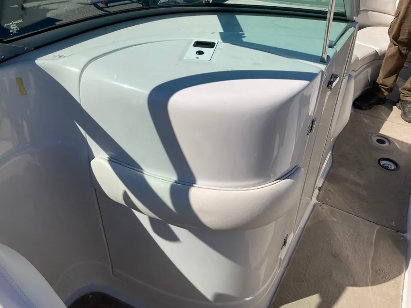 Slide: The Image of 2007 Crownline 260 LS boat interior with white seating and beige flooring. - 14