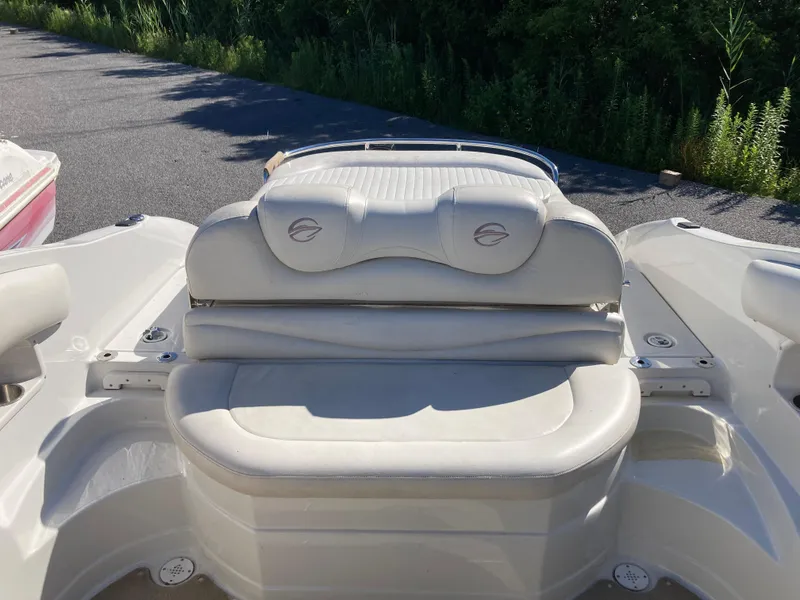 Slide: The Image of 2007 Crownline 260 LS boat with white seating, parked on a sunny day. - 6