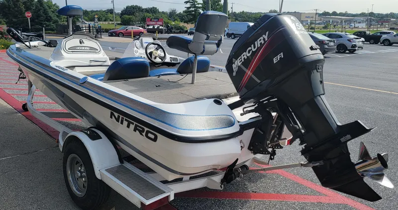 Slide: The Image of 2006 Nitro 482 DC boat with Mercury EFI engine on trailer in parking lot. - 4