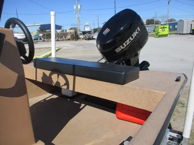 Slide: The Image of 2023 Rabco 16 Buccaneer boat with Suzuki outboard motor, parked outdoors. - 7