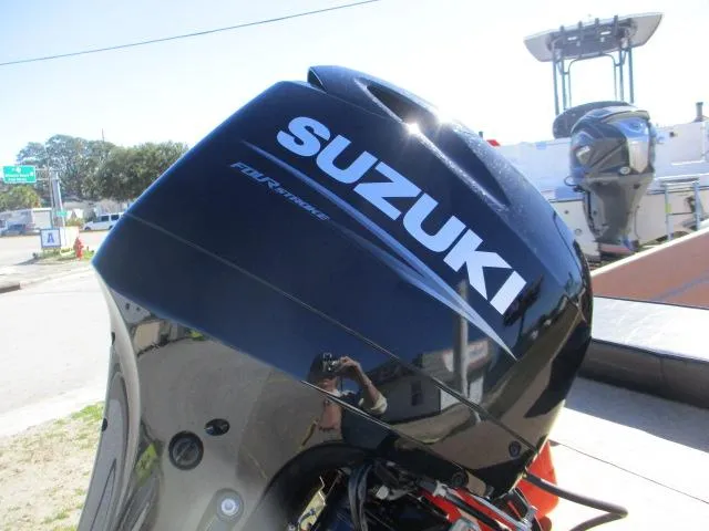 Slide: The Image of Suzuki outboard motor on 2023 Rabco 16 Buccaneer boat, outdoor setting. - 8