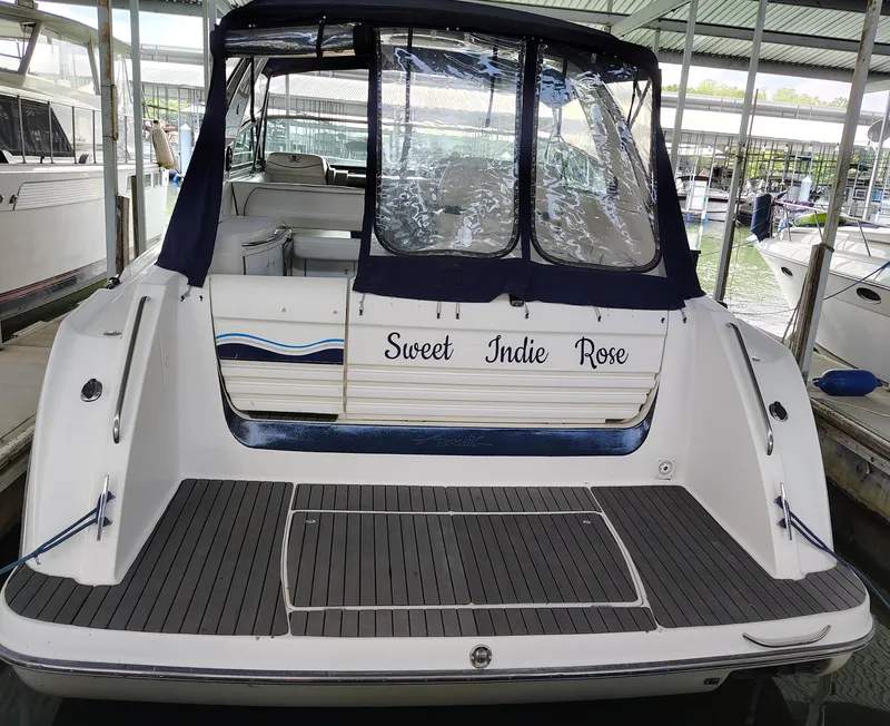 Slide: The Image of 1997 Bayliner 4085 Avanti boat docked, named "Sweet Indie Rose," with covered seating area. - 11
