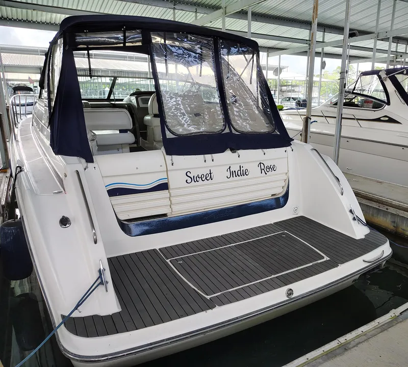 Slide: The Image of 1997 Bayliner 4085 Avanti boat named "Sweet Indie Rose" docked in a covered marina. - 12