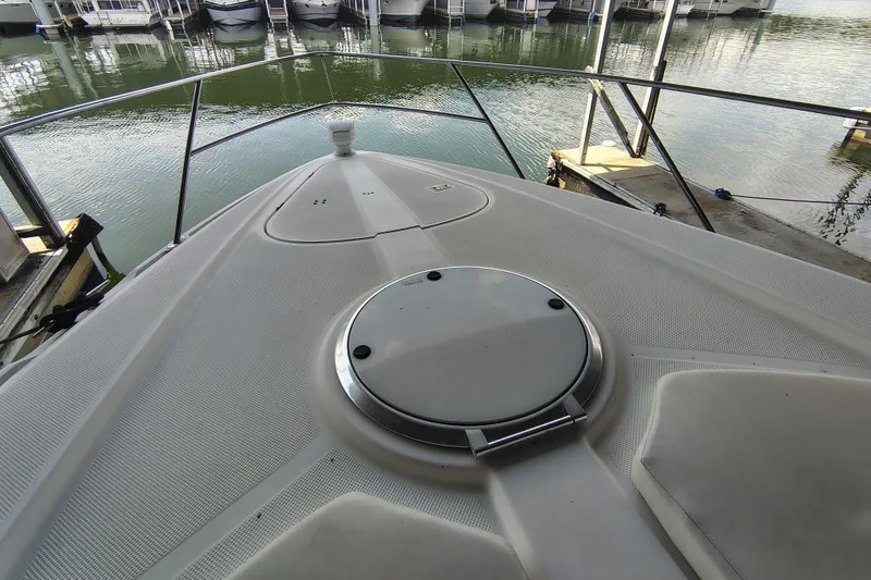 Slide: The Image of 1997 Bayliner 4085 Avanti boat deck at marina, featuring sleek design and water view. - 14