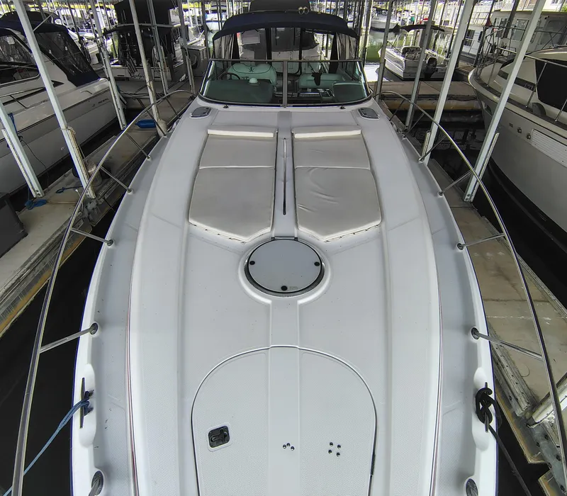 Slide: The Image of 1997 Bayliner 4085 Avanti yacht docked in a marina, showcasing its spacious deck. - 15