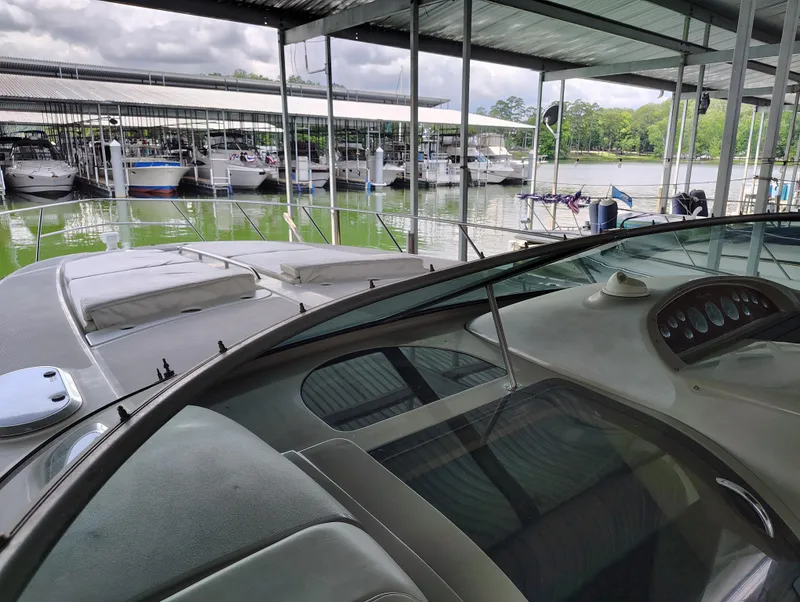 Slide: The Image of 1997 Bayliner 4085 Avanti docked in a marina with other boats. - 18
