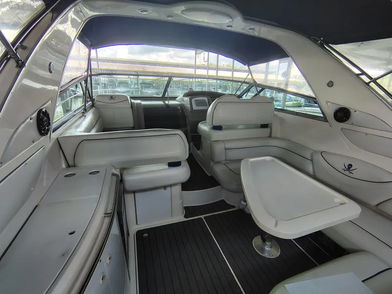 Slide: The Image of 1997 Bayliner 4085 Avanti yacht interior with white seating and table, featuring modern design elements. - 19