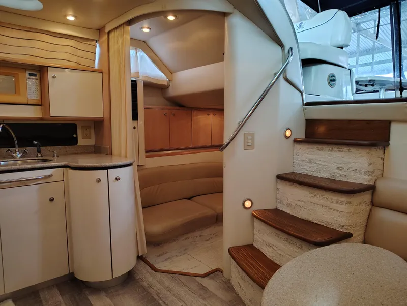 Slide: The Image of Interior of 1997 Bayliner 4085 Avanti yacht with kitchen and seating area. - 2