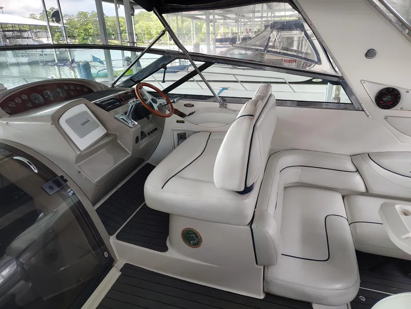 Slide: The Image of 1997 Bayliner 4085 Avanti boat interior with white seating and modern dashboard. - 21