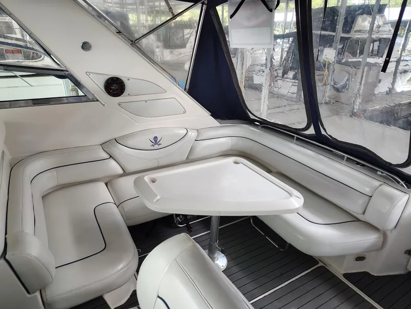 Slide: The Image of 1997 Bayliner 4085 Avanti interior with white seating and table, enclosed by clear windows. - 22