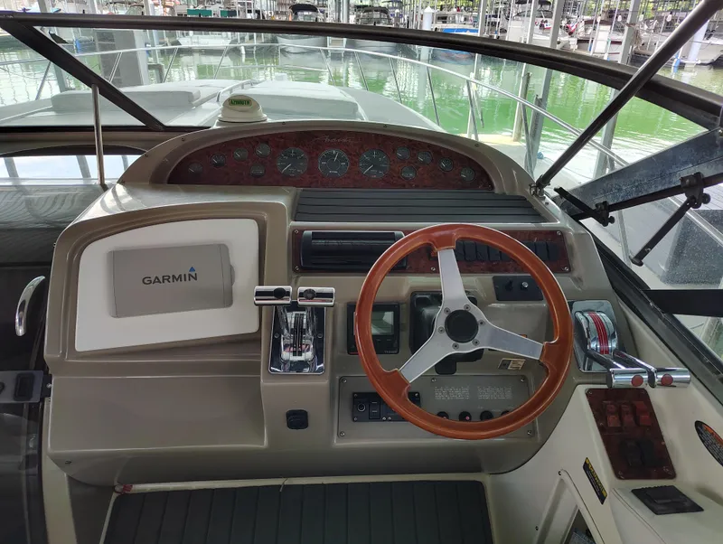 Slide: The Image of 1997 Bayliner 4085 Avanti helm with Garmin navigation and wooden steering wheel. - 26