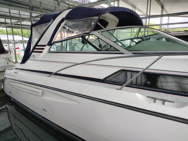 Slide: The Image of 1997 Bayliner 4085 Avanti boat docked in a covered marina. - 3