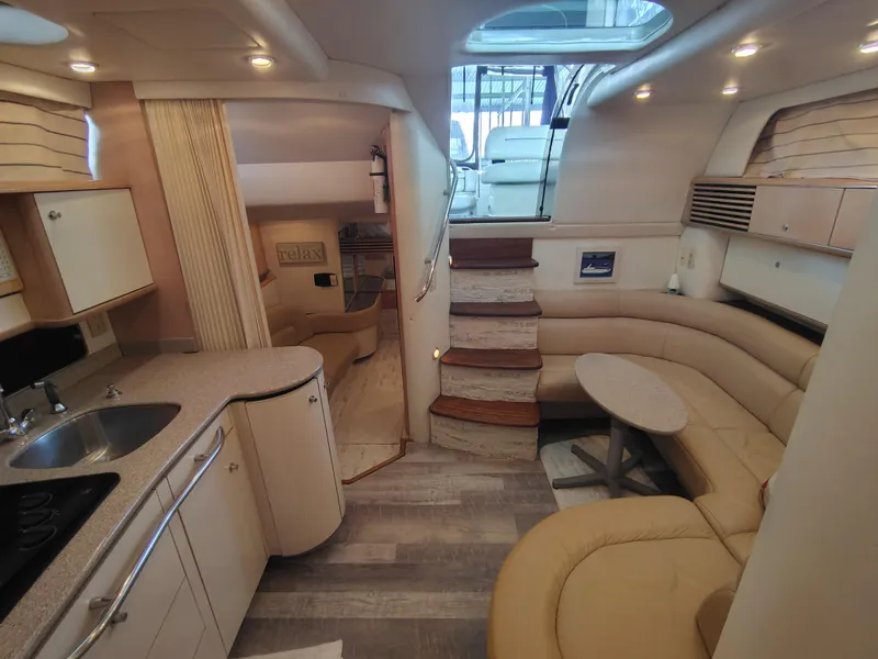 Slide: The Image of Interior of 1997 Bayliner 4085 Avanti yacht with kitchen, seating area, and stairs. - 30