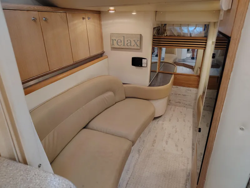 Slide: The Image of Interior of 1997 Bayliner 4085 Avanti yacht with beige seating and wooden cabinets. - 35