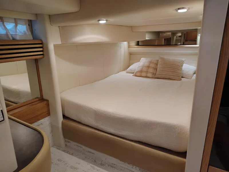 Slide: The Image of Luxurious cabin interior of 1997 Bayliner 4085 Avanti with cozy bed and ambient lighting. - 36