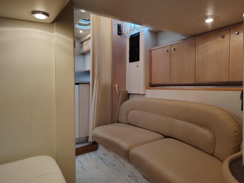 Slide: The Image of Interior of 1997 Bayliner 4085 Avanti yacht with beige seating and wooden cabinets. - 37