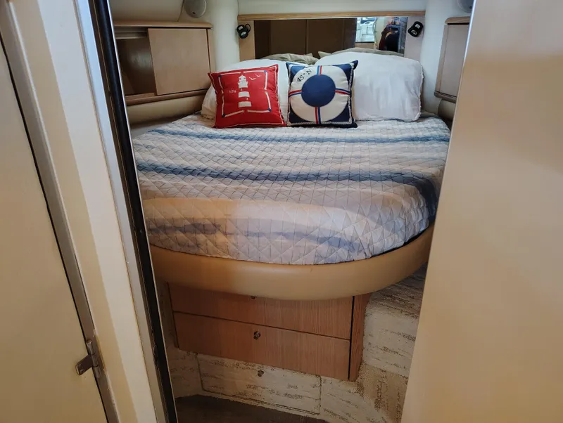 Slide: The Image of Cozy bedroom in 1997 Bayliner 4085 Avanti yacht with nautical-themed pillows. - 39