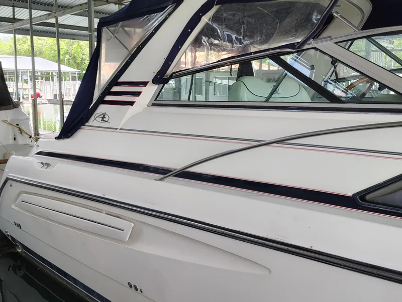 Slide: The Image of 1997 Bayliner 4085 Avanti boat docked under a covered marina. - 4