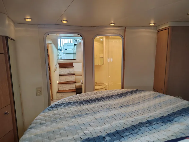 Slide: The Image of Interior of 1997 Bayliner 4085 Avanti yacht, featuring bedroom and bathroom. - 40
