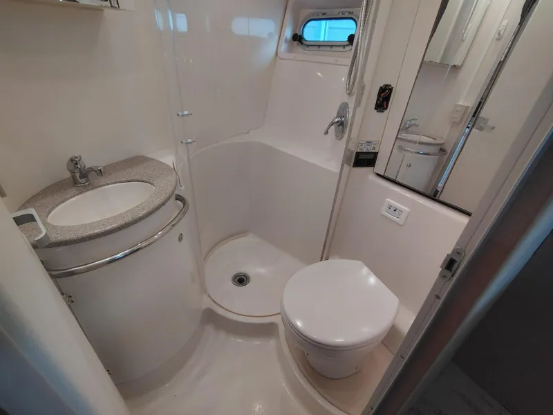 Slide: The Image of Bathroom interior of 1997 Bayliner 4085 Avanti yacht, featuring sink, toilet, and shower. - 42
