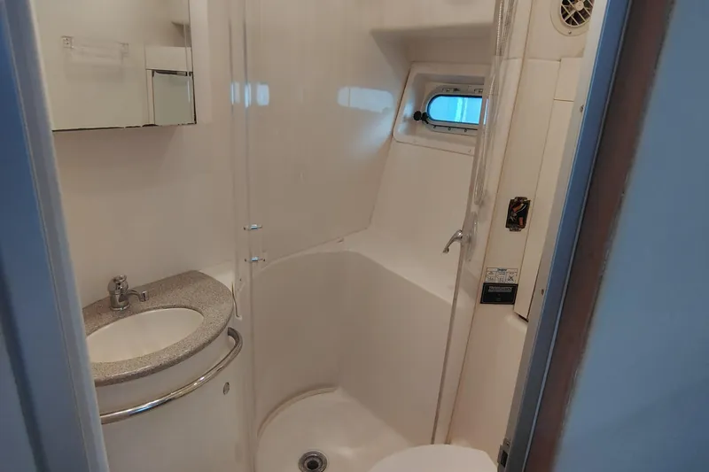 Slide: The Image of Bathroom interior of 1997 Bayliner 4085 Avanti yacht, featuring sink and shower. - 44