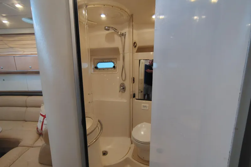 Slide: The Image of Interior of 1997 Bayliner 4085 Avanti yacht showing bathroom and seating area. - 45