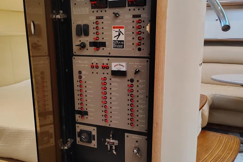 Slide: The Image of Electrical control panel inside 1997 Bayliner 4085 Avanti yacht, featuring switches and indicators. - 46