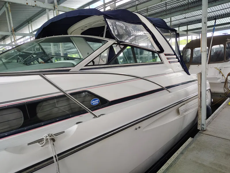 Slide: The Image of 1997 Bayliner 4085 Avanti docked in a covered marina, side view. - 6