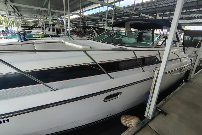 Slide: The Image of 1997 Bayliner 4085 Avanti docked in a covered marina, side view. - 7