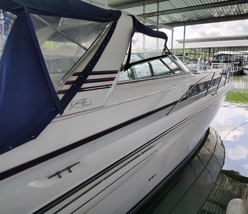 Slide: The Image of 1997 Bayliner 4085 Avanti boat docked under a covered marina. - 8